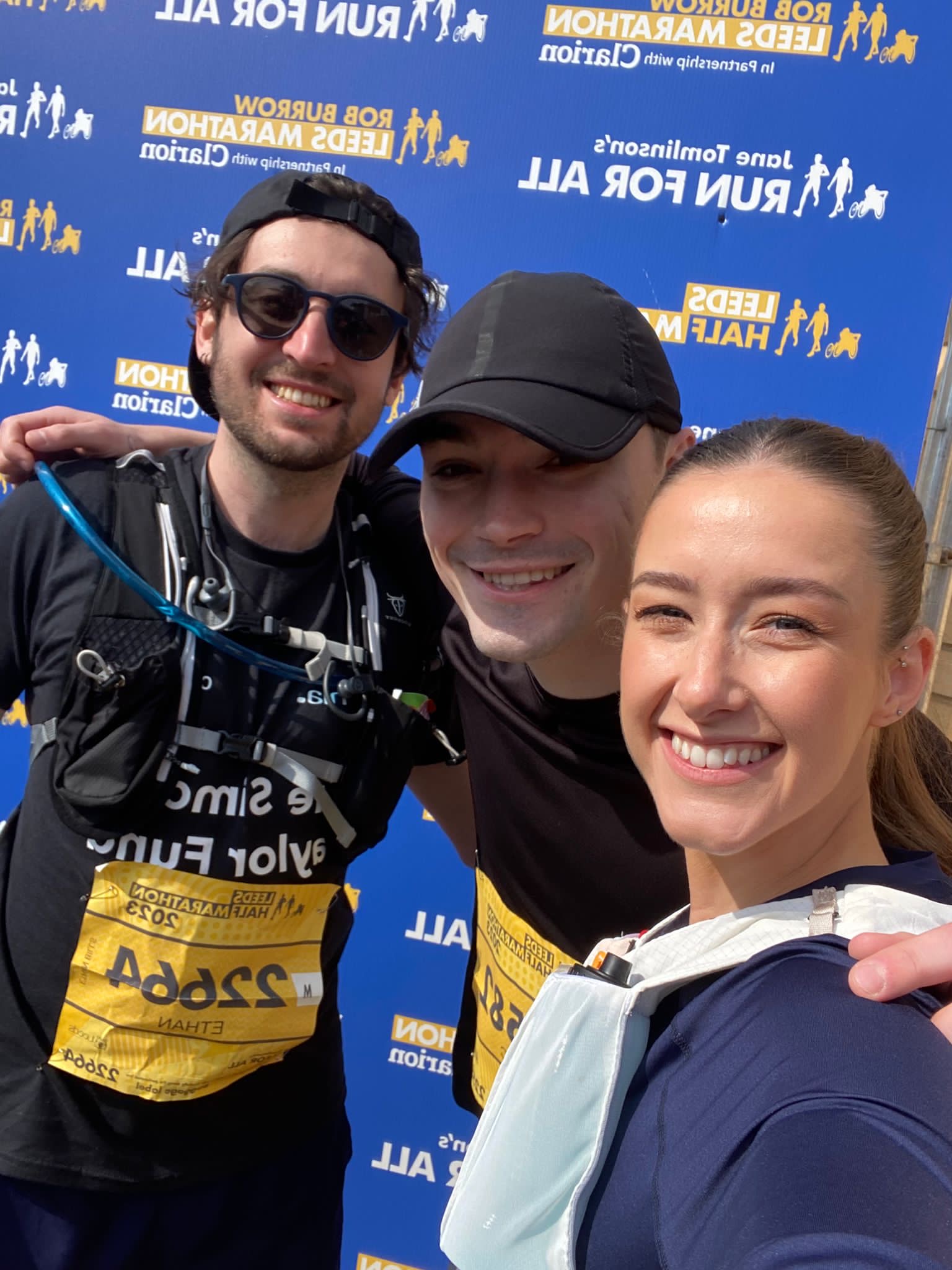 3 of our employees celebrating with their marathon medals
