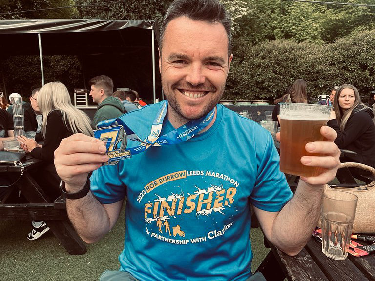 CEO Paul celebrating with his marathon medal