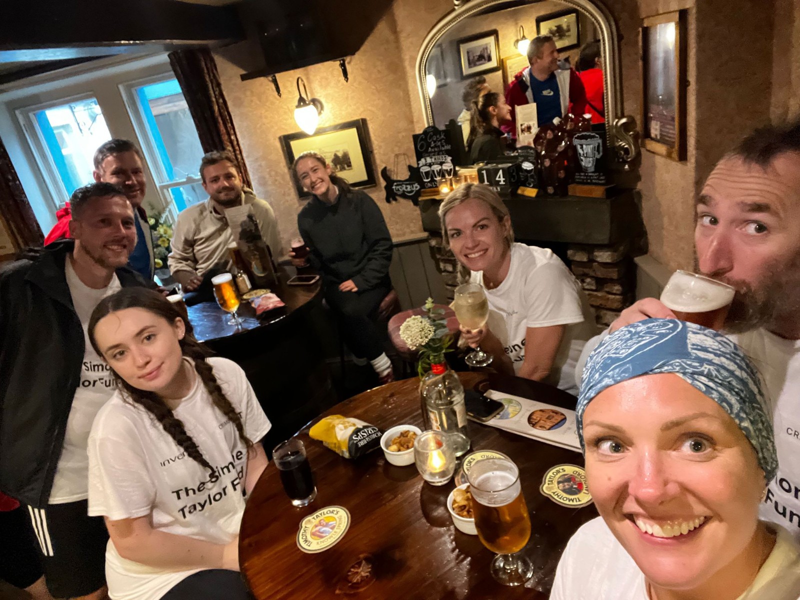invenia team members enjoying a drink at the pub after a 26 mile hike