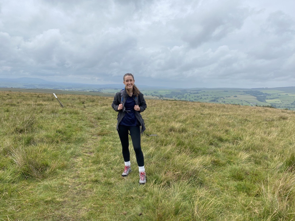 Invenia employee hiking in the rain
